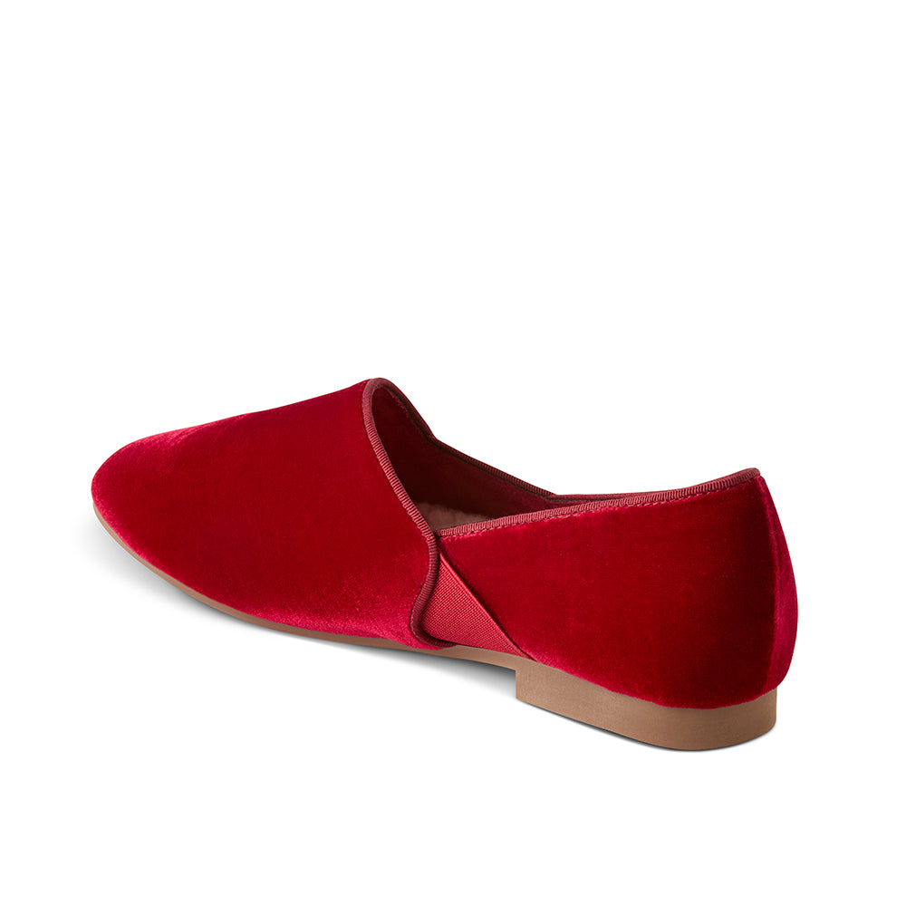 Side view of Luvons Francesca luxury loafer in Ruby Red featuring a sleek velvet upper, flexible gore for effortless movement, and a low-profile sole for indoor and outdoor wear.